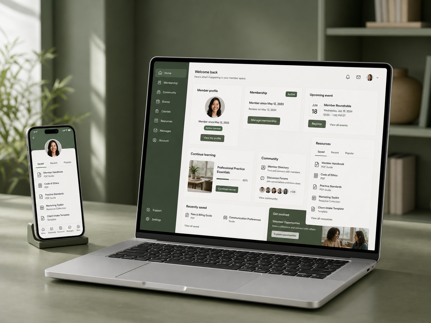 Member portal software shown on an angled laptop with saved resources on a phone